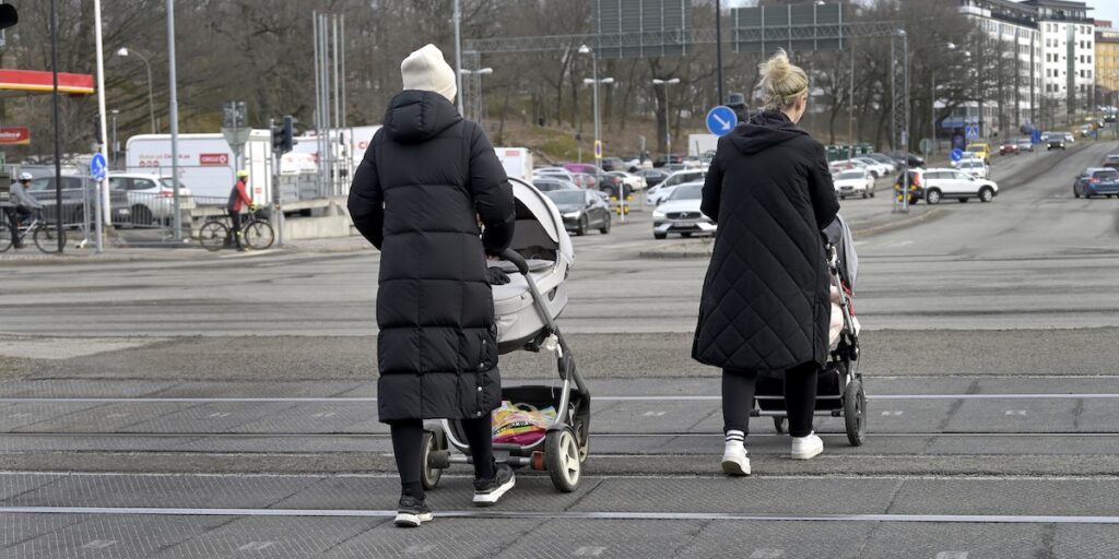 Två kvinnor med barnvagn promenerar utomhus. Skandia 2025: psykisk ohälsa ökar bland kvinnor, särskilt under småbarnsåren.